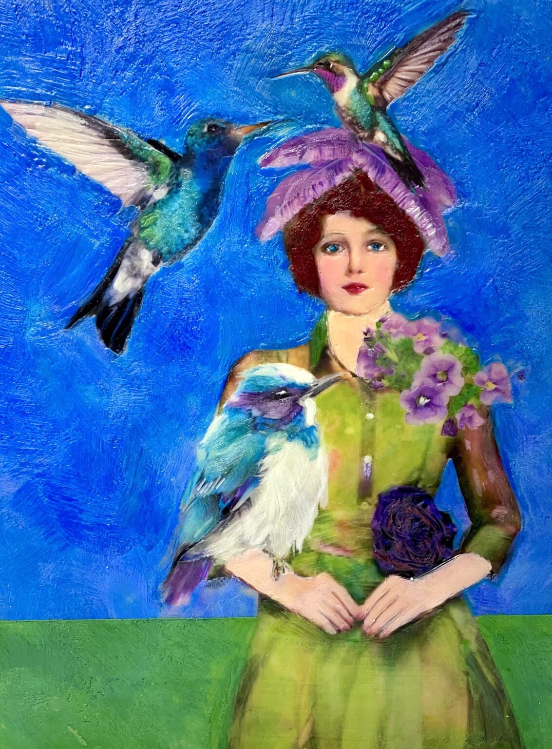 Encaustic collage depiction of a woman with humming birds and flowers against a blue background