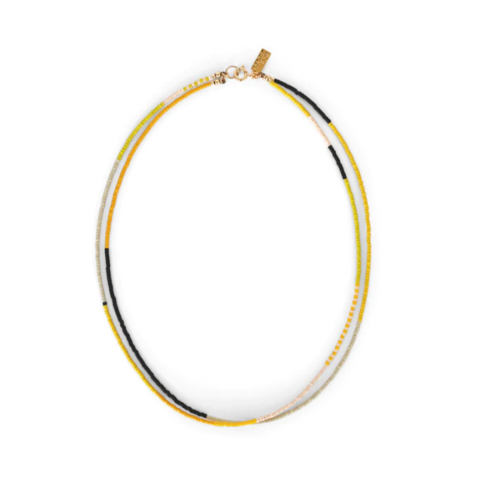 A Yellow Sun double stranded necklace by Abacus Row is a sunny bright palette of pink and yellow hues accented with sharp black detail to welcome a bright and hopeful summer. 