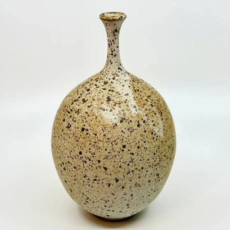 No 37 vase by Dana Chieco Ceramics is a deep speckled clay with deep amber areas that give it a sublime contrast and glazed in matte white. Try it with a single weed stem or dried flower.