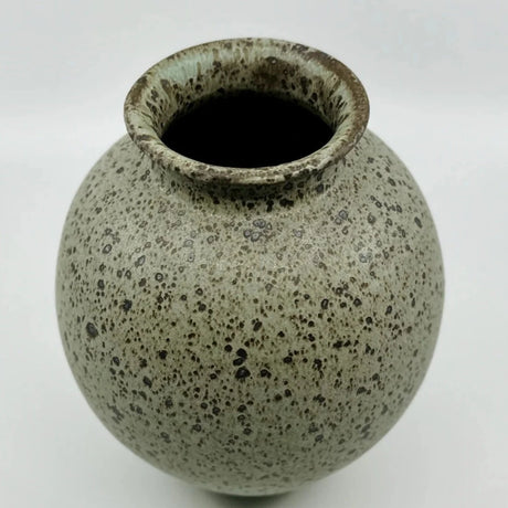 This Dana Chieco No 36 wide mouth vase provides ample room for a peony bouquet! The ceramic vase is wheel thrown with deep speckled clay and glazed in blue-pistachio tone.