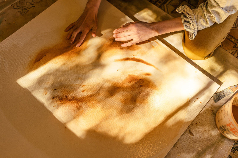 Danielle Hutchens painting with earth pigments made from rocks ground into powder and mixed with medium