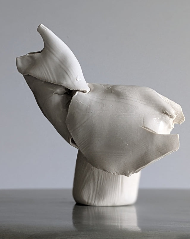 Abstract ceramic bird sculpture on a gray background