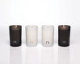 Group shot of the 4 elements collection candles by Free Yourself in tall 4 oz votives: Air, Eau (water), Feu (fire) and Terre (Earth)