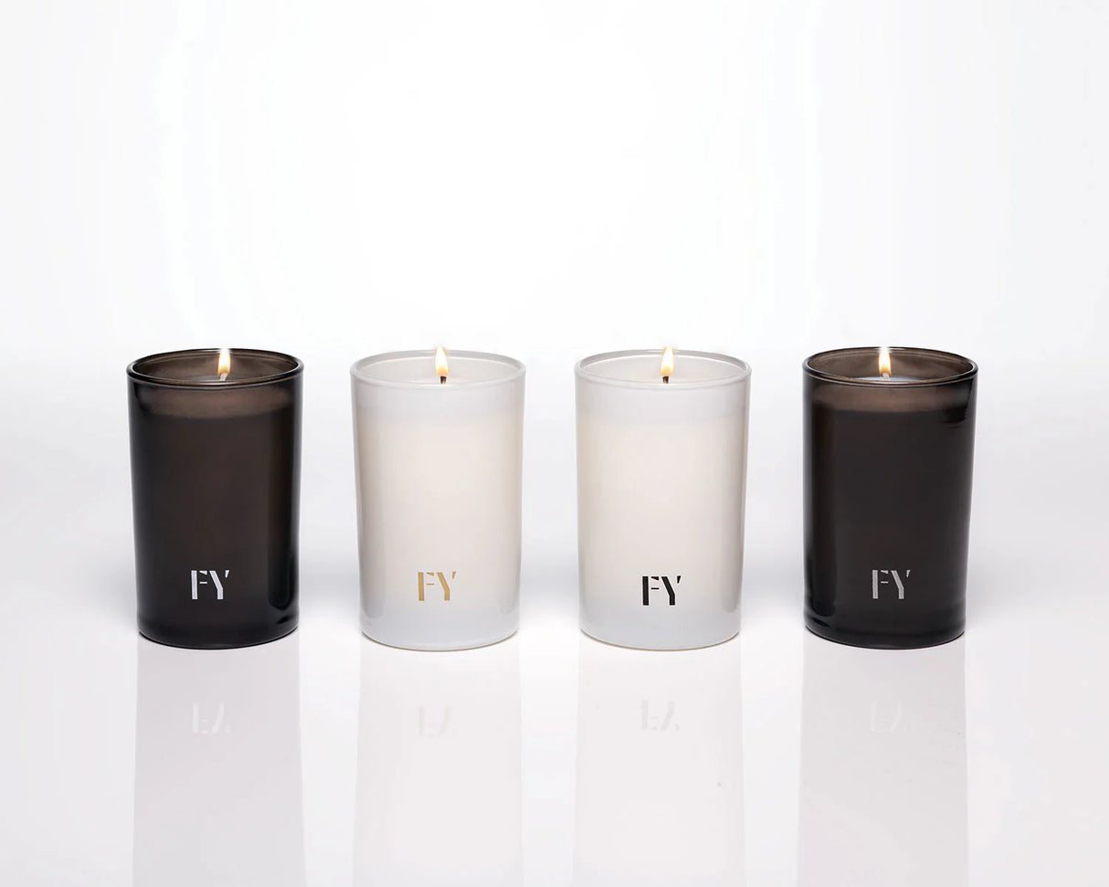 Group shot of the 4 elements collection candles by Free Yourself in tall 4 oz votives: Air, Eau (water), Feu (fire) and Terre (Earth)