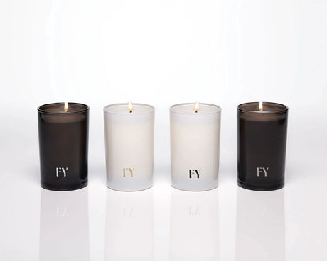 Group shot of the 4 elements collection candles by Free Yourself in tall 4 oz votives: Air, Eau (water), Feu (fire) and Terre (Earth)