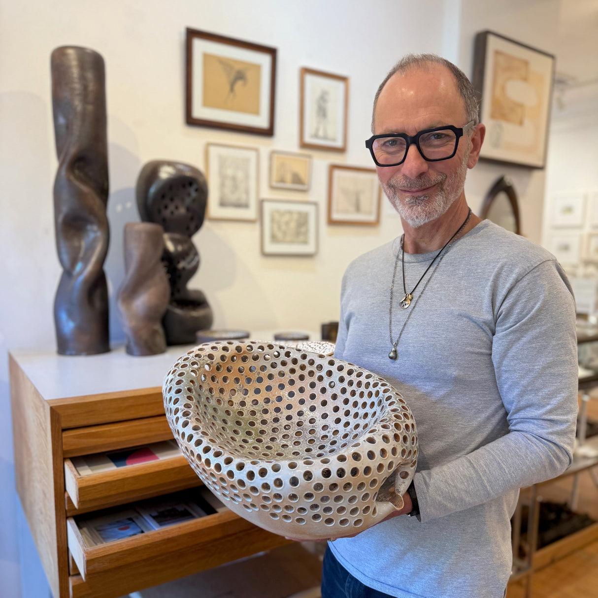 Jeffrey Levin holding Ian Hazard Bill basin bowl in the art gallery