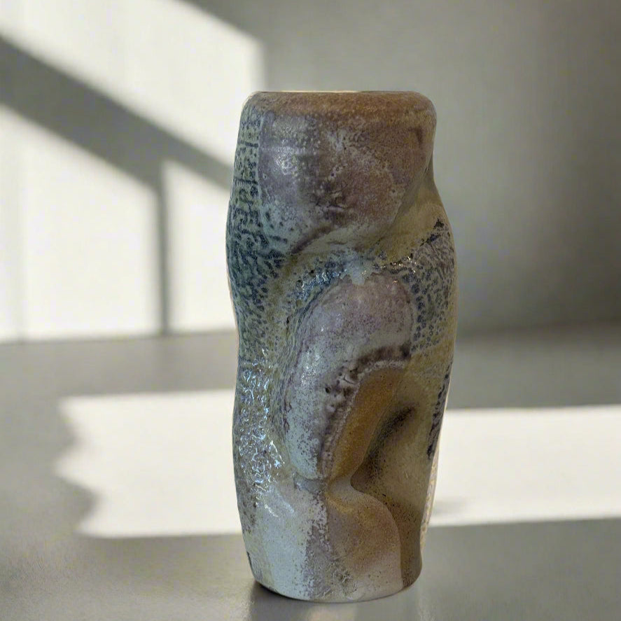 We love a petite vase to layer with other objects. Ian Hazard Bill makes these one-of-a-kind wood fired ceramic ripple vases perfect for a small bouquet.