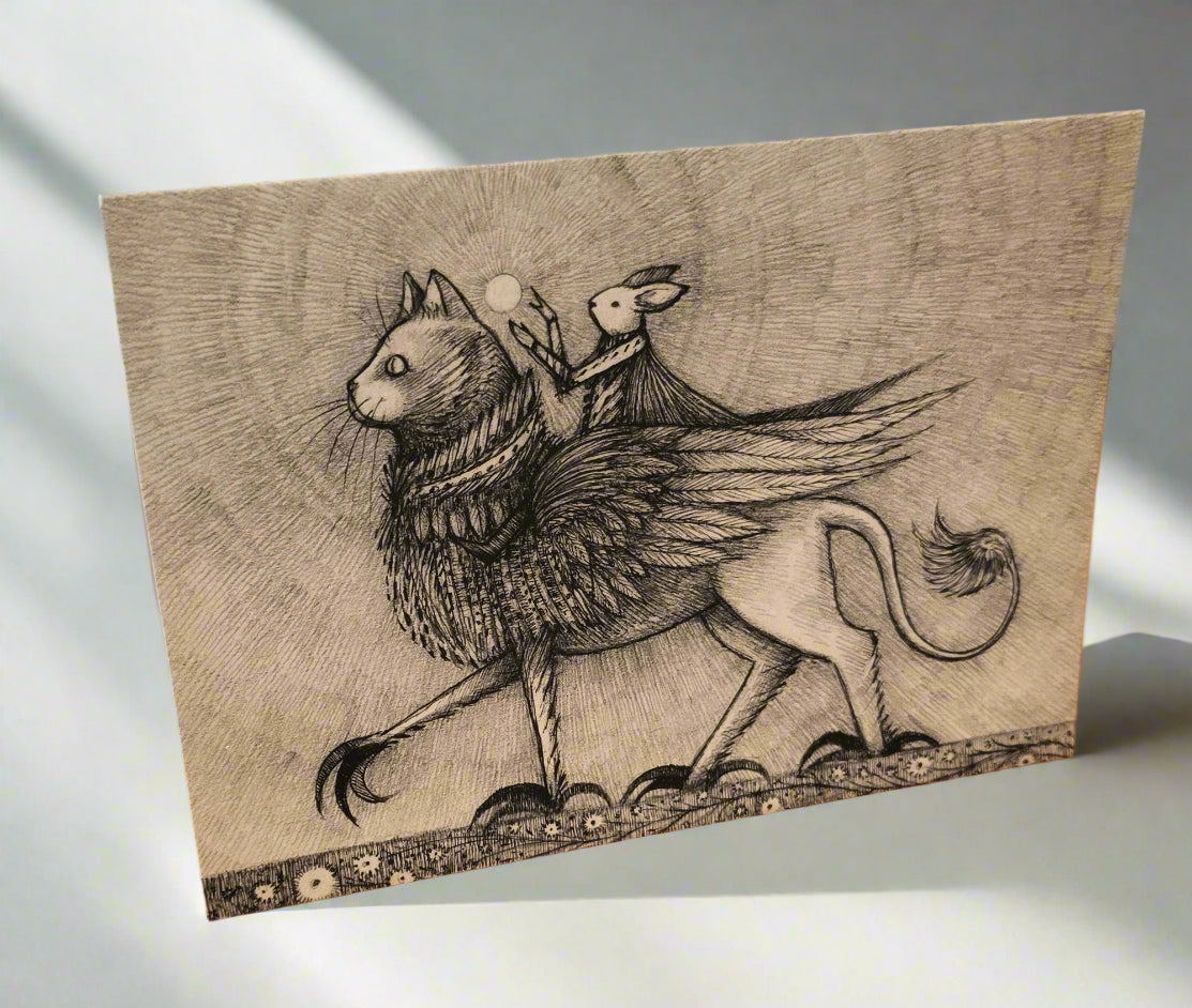 Greeting card with a stylized illustration of a winged cat creature and a small figure riding the cat