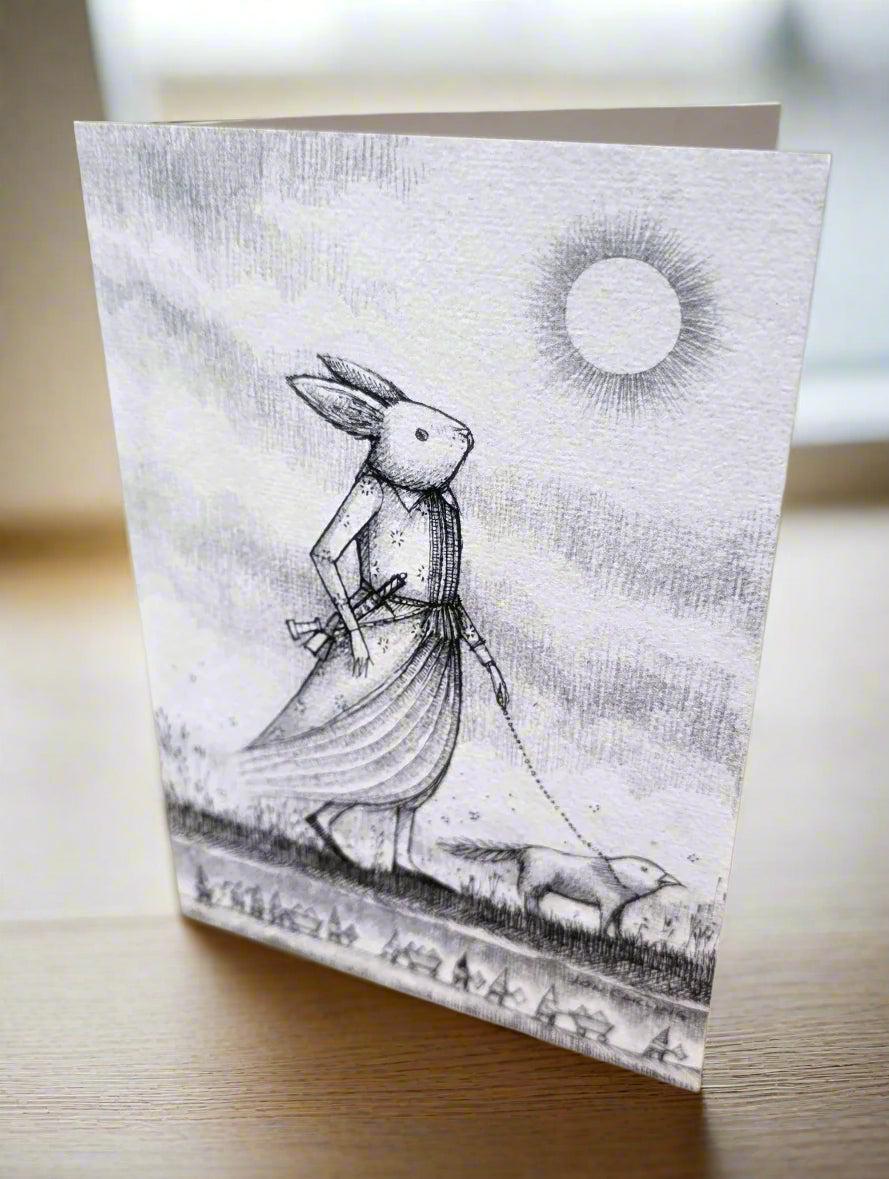Greeting card with a black and white illustration of a rabbit walking a bird dog.