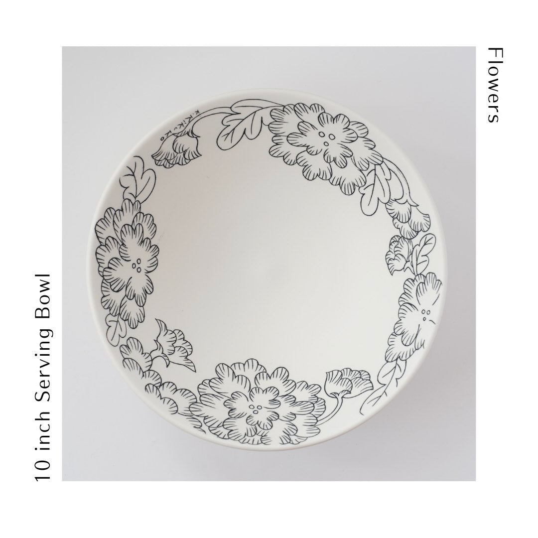 This 10" serving bowl in porcelain is great for a spring salad, pasta or a decorative object. The bowl is wheel thrown and then decorated in an inlay technique of flowers.