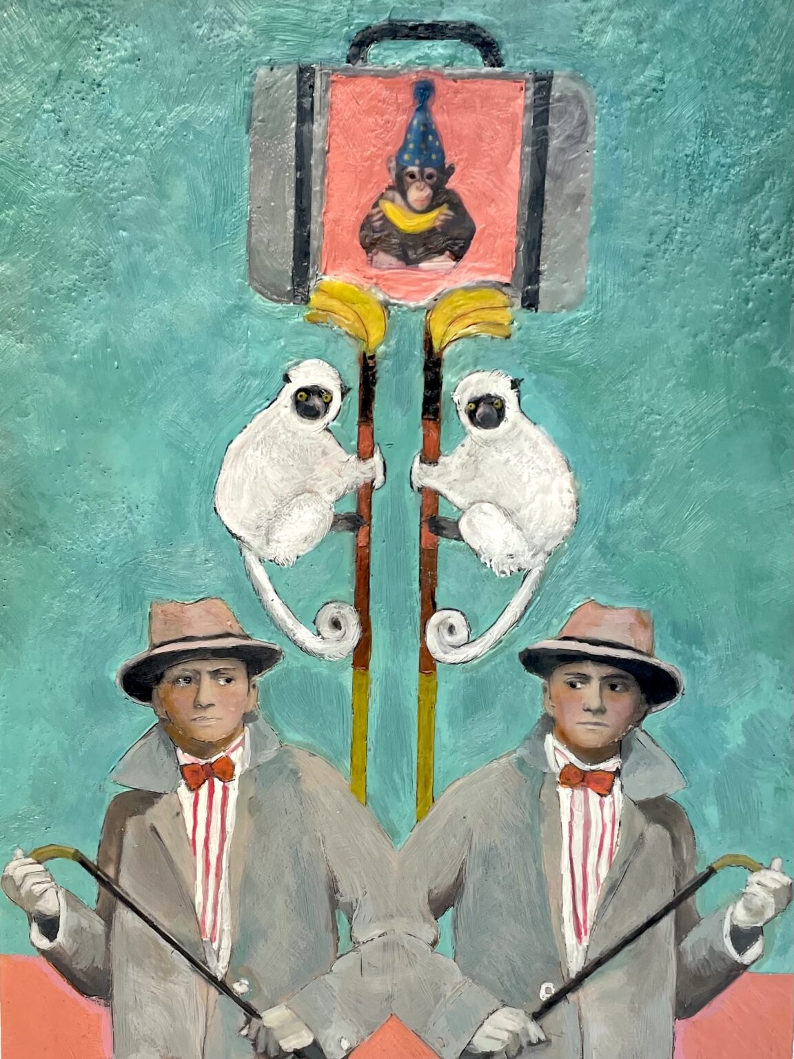 Two men in suits with bow ties stand next to a suitcase with a monkey painted on the outside, on a teal background.