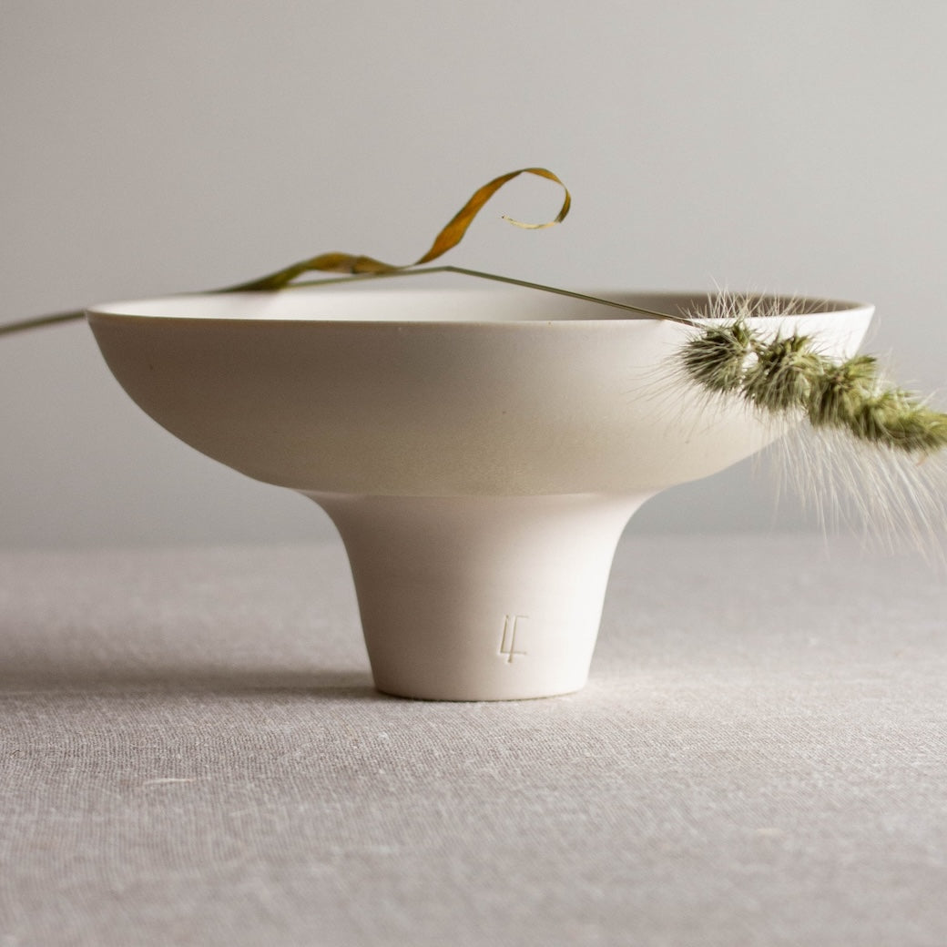 Open form with tall foot. One of a kind white crystalline matte porcelain objects are mid-century Scandinavian inspired by Lisa Fleming.