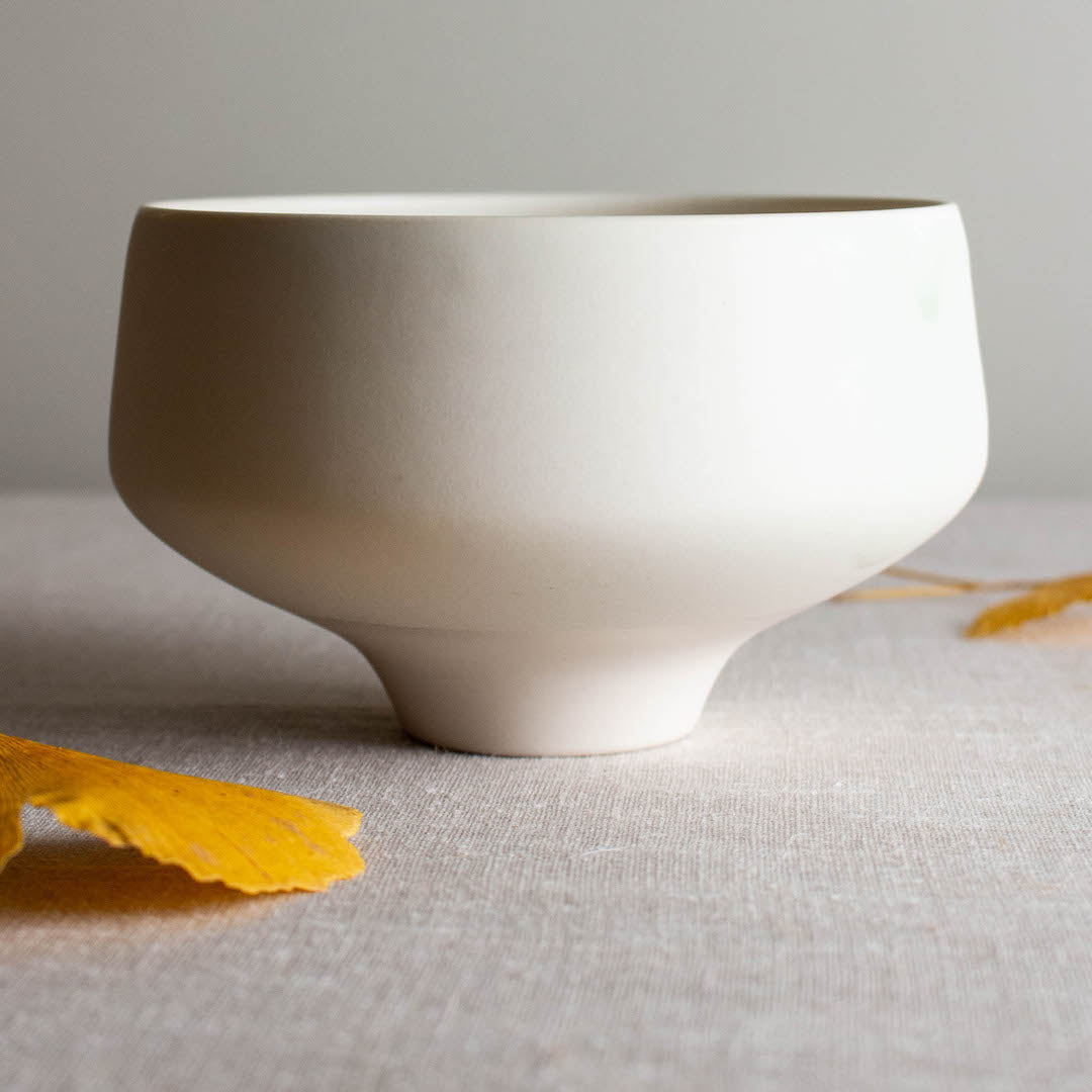Straight sided bowl with blue flash. One of a kind white crystalline matte porcelain objects are mid-century Scandinavian inspired by Lisa Fleming.