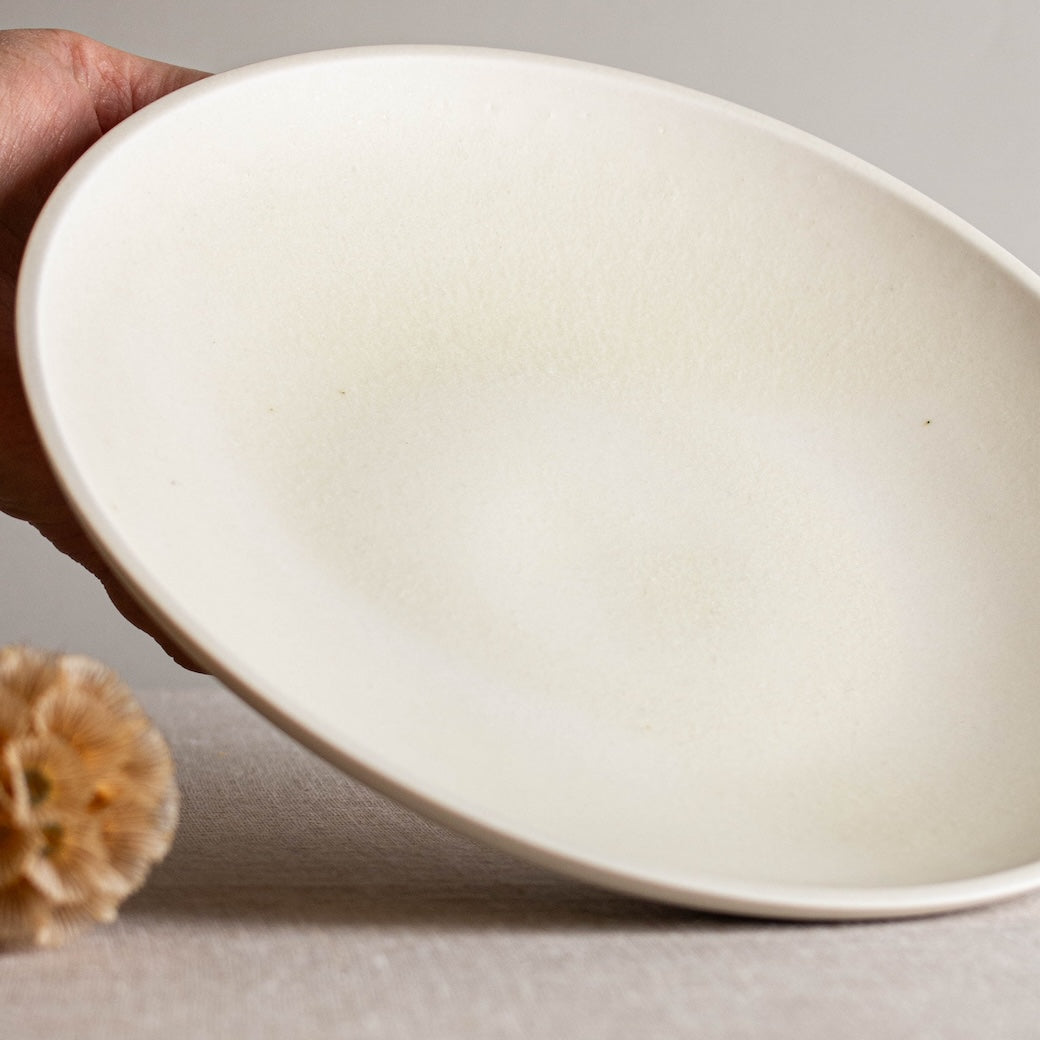 Low, wide open form. One of a kind white crystalline matte porcelain objects are mid-century Scandinavian inspired by Lisa Fleming.