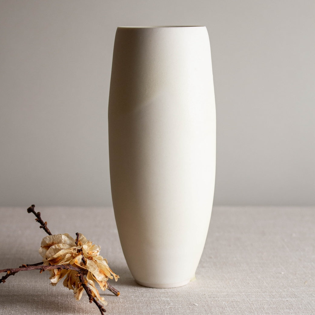 Tall, narrow vase form. One of a kind white crystalline matte porcelain objects are mid-century Scandinavian inspired by Lisa Fleming.
