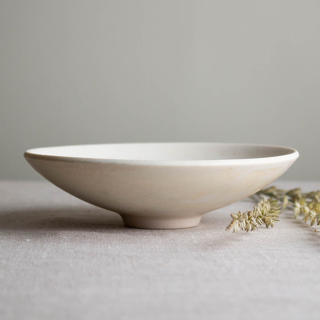 Small open form dish with Kintsugi bottom. One of a kind white crystalline matte porcelain objects are mid-century Scandinavian inspired by Lisa Fleming.