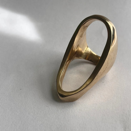 It's the airy space that grabs attention, not to mention the bold form of Lotte's open oval "Brunel" ring!