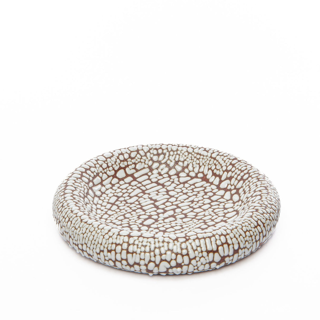 Shaped somewhat like a donut, the Torus bowl by MH Ceramics is round and pillowy with a soft concave center. A great catch-all and decor object that is begging to be touched.