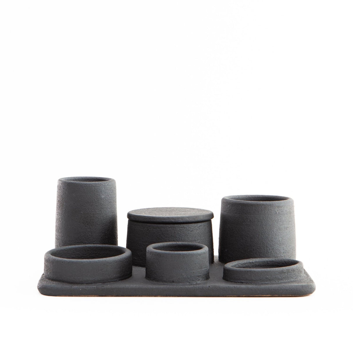 Hand built ceramic organizer tray with various sized containers; some have lids and others do not.