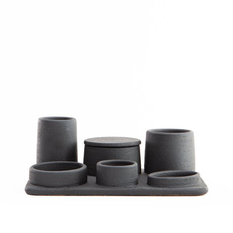 Hand built ceramic organizer tray with various sized containers; some have lids and others do not.