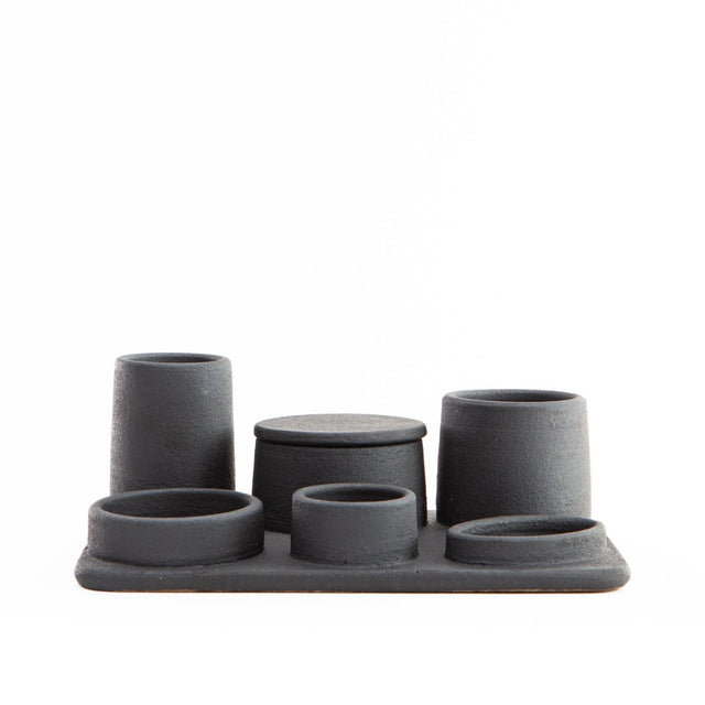 Hand built ceramic organizer tray with various sized containers; some have lids and others do not.