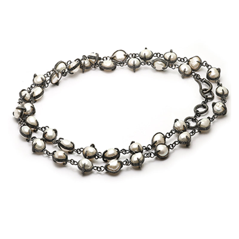 A chain of pearls ensconced in oxidized silver claws to surround your neck.