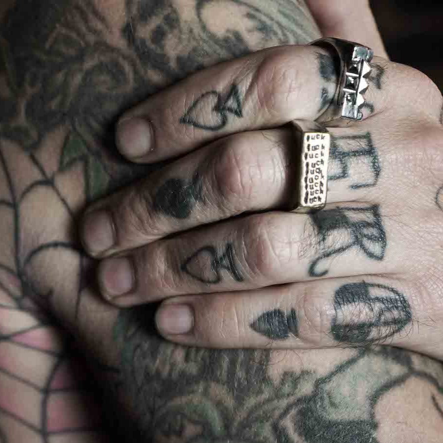 Shown on model. Anna designed this ring for the current times! Sterling silver signet ring with 23K gold foil on the face of the ring is carved in wax and then sand cast in house and stamped with the f-word, multiple times!