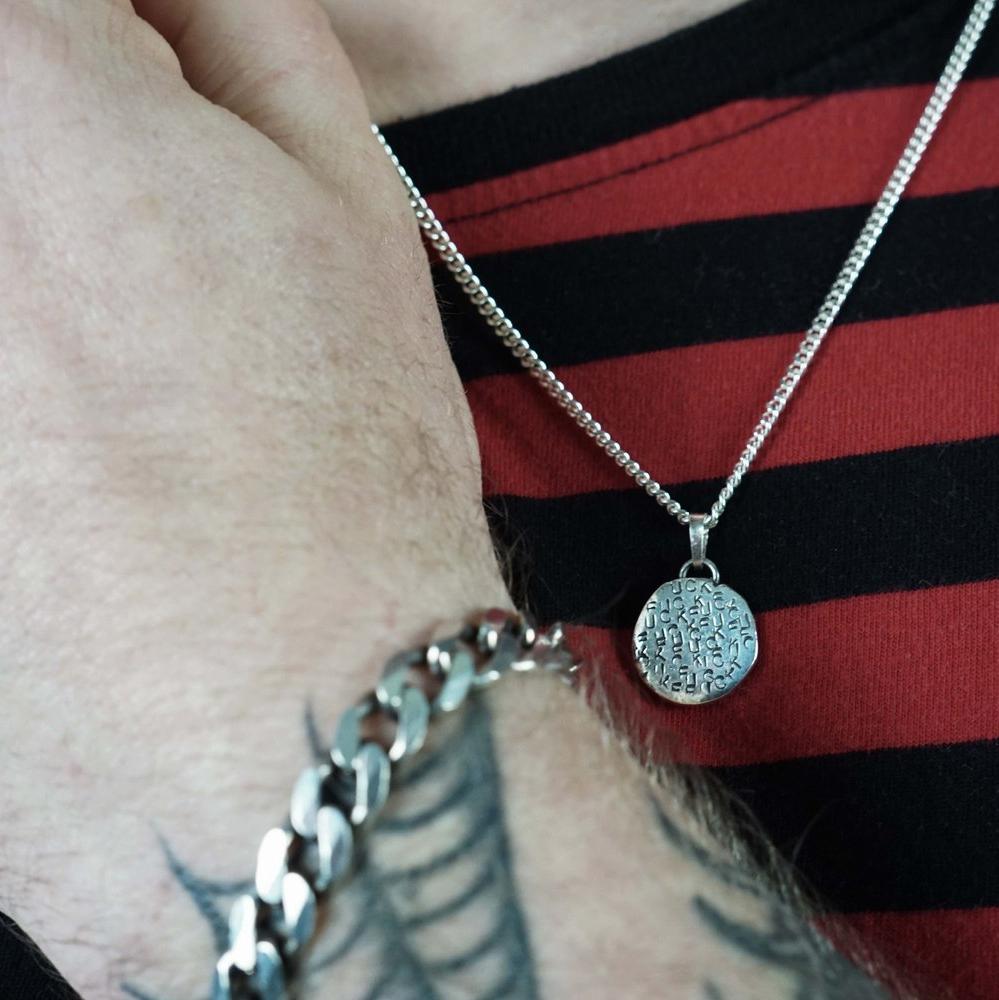 Self expression rules with this f-stamped silver medallion. Individually hand sand cast and stamped with multiple f_s. Made by Metal Atelier jewelry in Berlin, this a collection of jewelry for rebels and dreamers! So many genderless options and designs for every body. Wear your power with a modern punk meets glam rock meets the organic characteristics of Japanese wabi-sabi aesthetic.