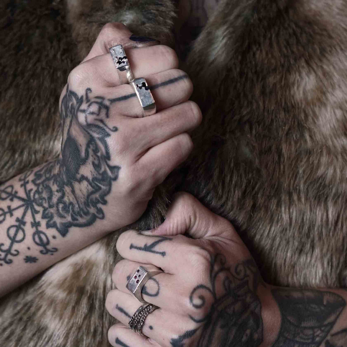 A gender fluid signet ring made by Metal Atelier from hand poured molten silver that is sand cast in a mould with natural sapphire or ruby gems.