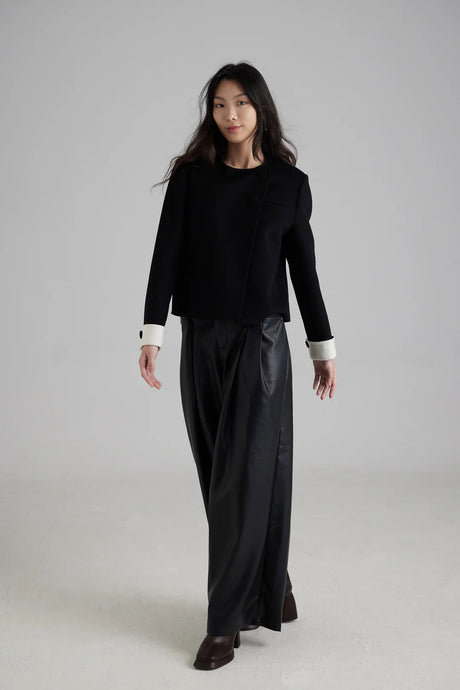 Sophisticated cropped jacket with white cuff detail and black fabric button