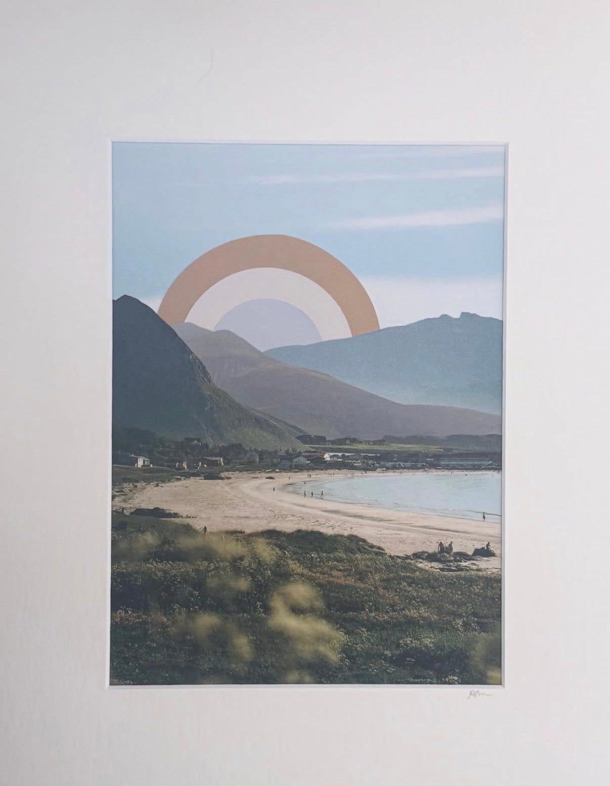 Collage landscape with mountains, ocean, and a cut paper sun in the sky.