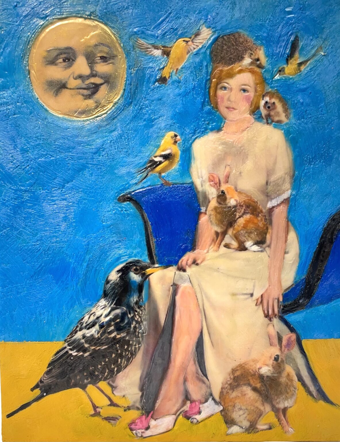 Encaustic collage art with a woman, animals, birds and a moon on a blue and yellow background