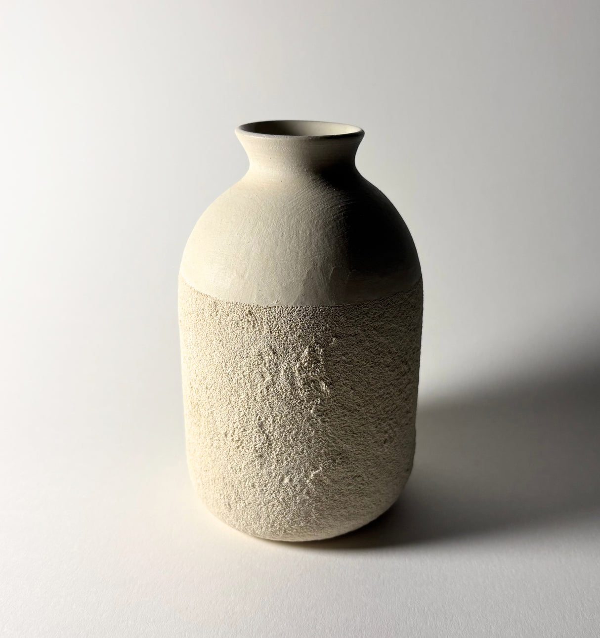 Avigail Remak ceramicist, desert inspired textured ceramic vase on a plain background