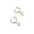The Amy in mini size are a pretty pearl hoop earring pair featuring freshwater cultured pearls. An oval shape with an ethereal opalescence, making for the perfect gift or a refined personal amulet.