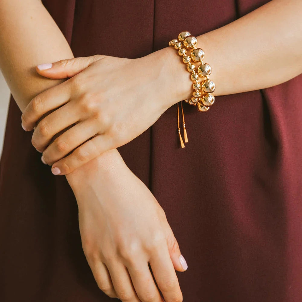 The Moon Sun Bracelet is an adjustable large gold ball bead bracelet that gives major wrist party vibes!