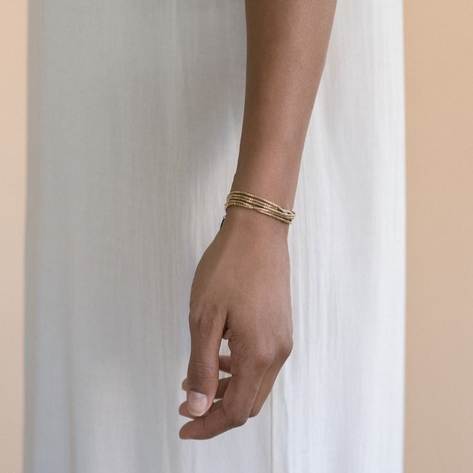 The Gobi is a convertible necklace to wrap bracelet made with 24k gold-plated Japanese glass beads and subtly accented with 14k gold-filled rounds.