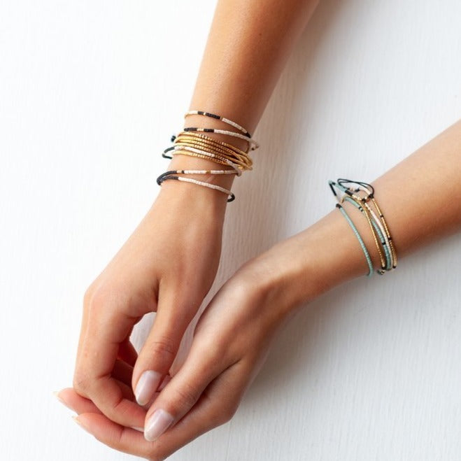 The Sonoran is a convertible necklace to wrap bracelet featuring playful patterns and designs made with Japanese glass beads.