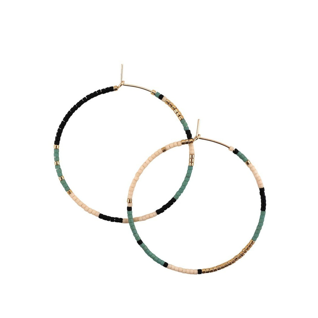 With Abacus Row's Tanami Hoops, designer Christina Trac plays with fixed and open pattern designs. Each earring hoop is hand hammered from 14k gold-filled wire and beaded by hand. These large hoops are whisper light for everyday adornment. Oasis