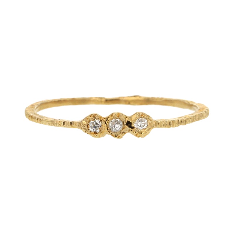 Add texture to your ring stack with this elegant yellow gold super skinny etched band set with three white diamonds by Danielle Welmond
