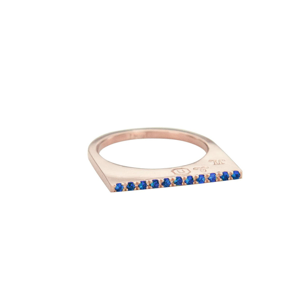 Add dramatic height and sparkle to your stacking rings with Jeffrey Levin's super flat skinnys encrusted in diamonds or colorful gems. Inspired by beautiful bon bon desert plating, Jeffrey Levin designed a unique proportion and stunning surface in 14k rose gold with pave set blue sapphires.