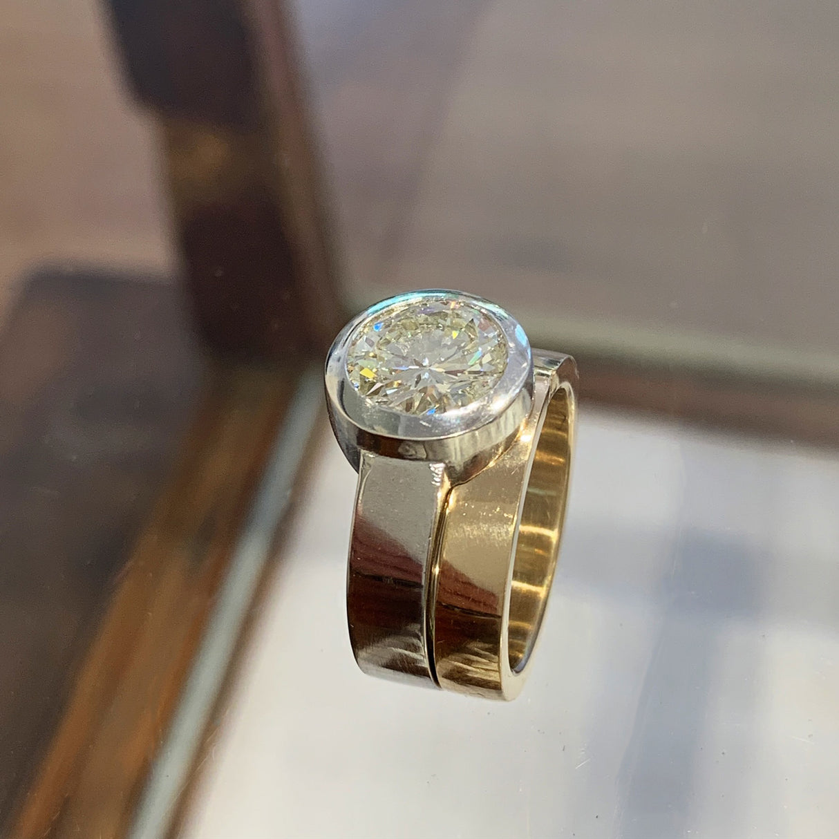 The custom designed engagement ring and wedding band fit snugly together and celebrate mixing metals with platinum and 14k gold.