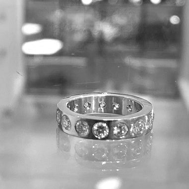 To fit with the yellow gold engagement ring, Jeffrey designed this diamond eternity wedding band in white gold to fit snuggly with the engagement ring.