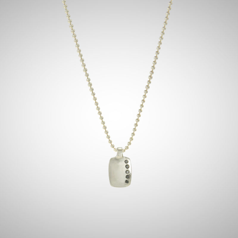 Jeffrey reimagined the classic dog tag into a modern canvas, both refined and a bit edgy. A river of black diamonds give this wabi sabi version beauty in the imperfections and elegance in simplicity.