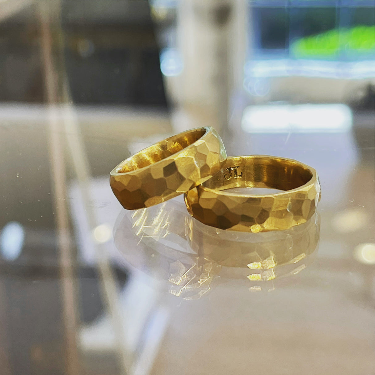 Jeffrey's hand carved wedding band in platinum has facets that captures the light. A unisex wide ring it is a modern option on its own or stacked with an engagement ring for stunning textural contrast. Yellow Gold wedding bands.