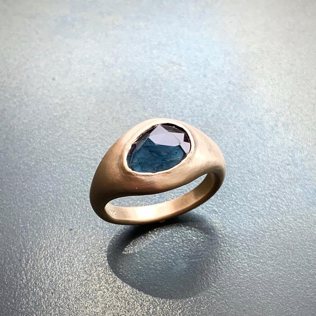A stone of protection & beauty, the blue tourmaline unleashes a bold color that changes in the light. This piece, in a brushed yellow gold setting specific to the shape of the brilliant blue stone, was hand crafted by Jeffrey Levin, Poet and/the Bench goldsmith and co-founder and is a bespoke design.
