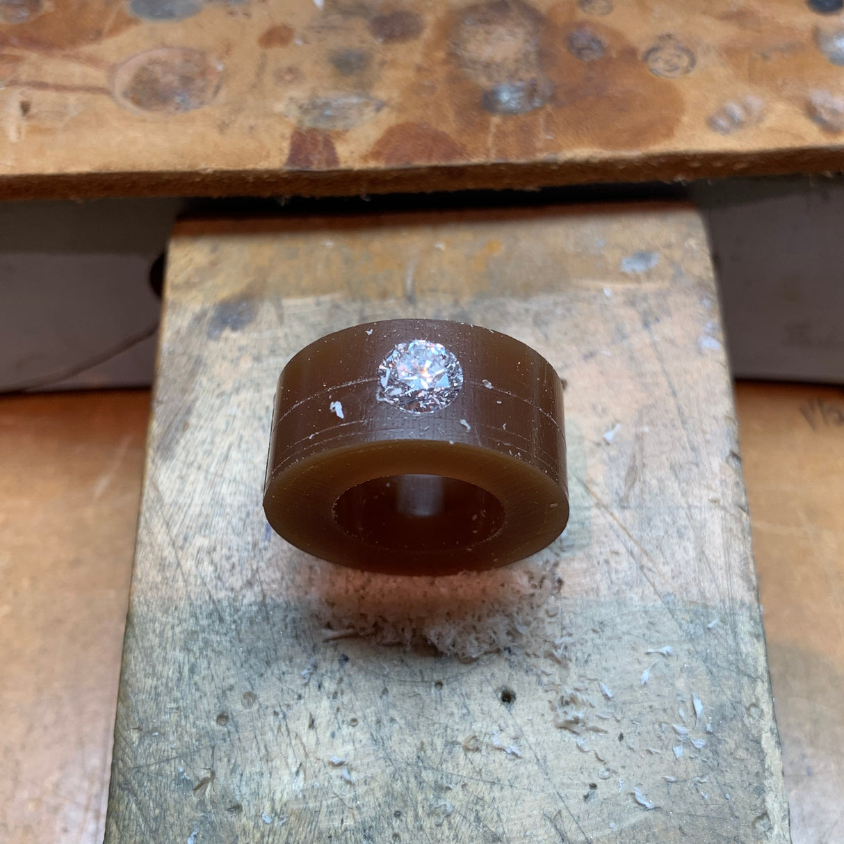 Jeffrey Levin hand carves the setting in wax to feature the diamond.