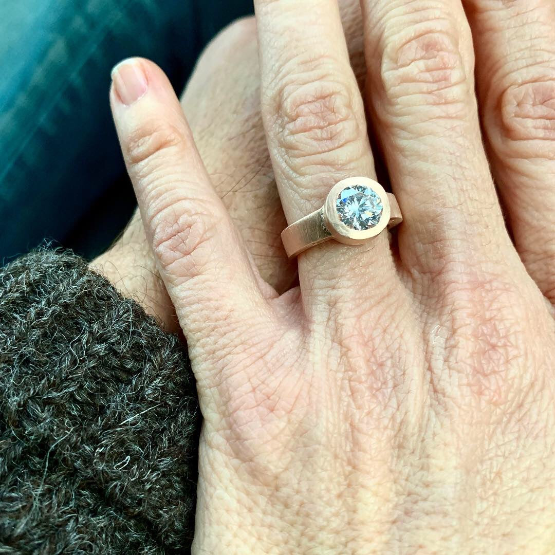 This design was created as a bespoke engagement ring by Poet and/the Bench co-founder and goldsmith Jeffrey Levin. Jeffrey's design specifically highlights the brilliant 1.25 carat diamond we sourced. The mounting was hand carved in wax and cast in 14k rose gold with Jeffrey’s signature flush-set design.