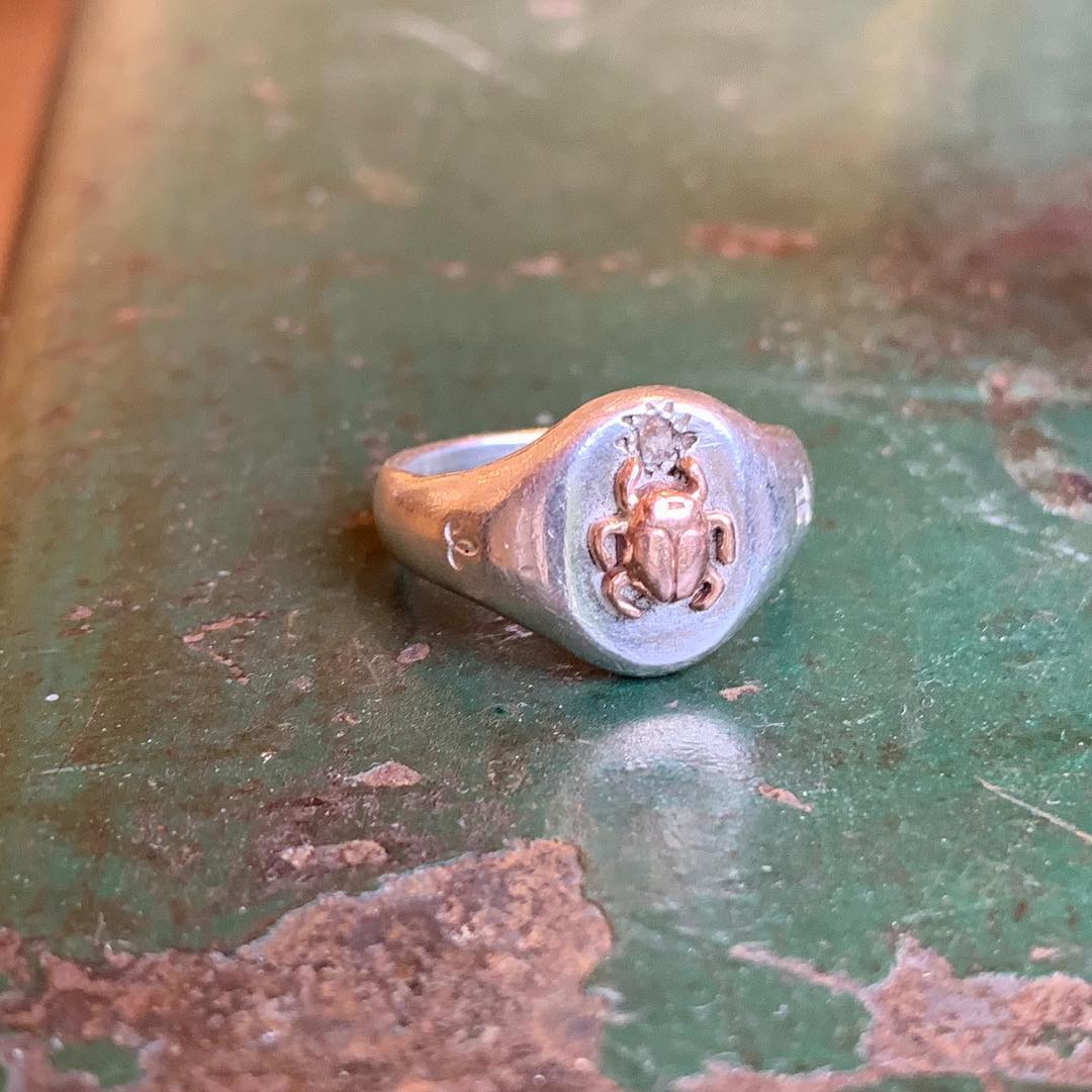 Jeffrey reimagines the classic Signet Ring, reworking it with feminine lines and using it as a canvas for other pretty and handsome things, like this contrasting scarab adornment in 14K rose gold with a star set white diamond.