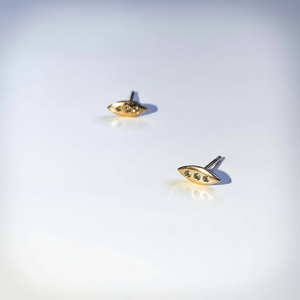 A tiny shield for protection, adorned in diamonds. Tiny earrings carved by hand in wax before being cast in precious metals. Rose gold and diamonds