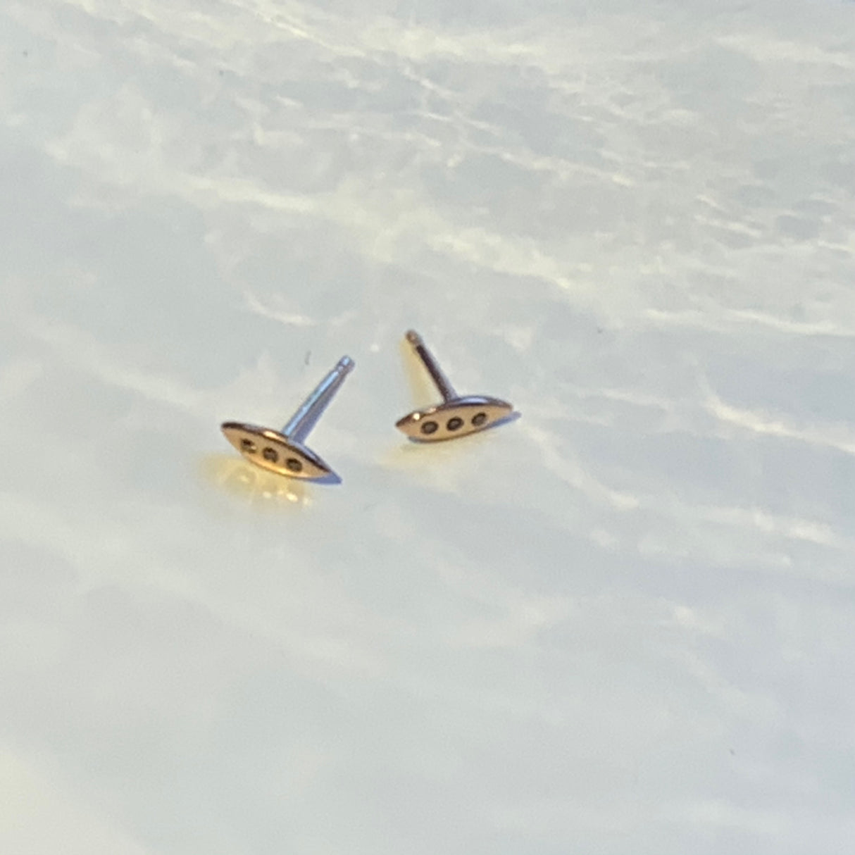 A tiny shield for protection, adorned in diamonds. Tiny earrings carved by hand by Jeffrey Levin in wax before being cast in precious metals. Cognac Diamonds set in Rose Gold.